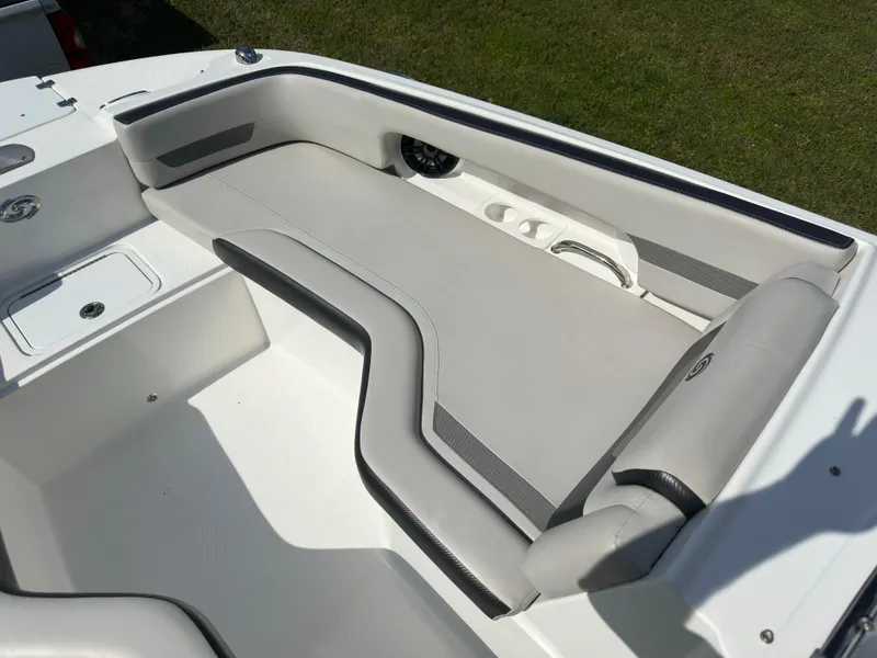 Slide: The Image of 2022 Hurricane SunDeck 235 OB boat interior with cushioned seating and cup holders. - 18