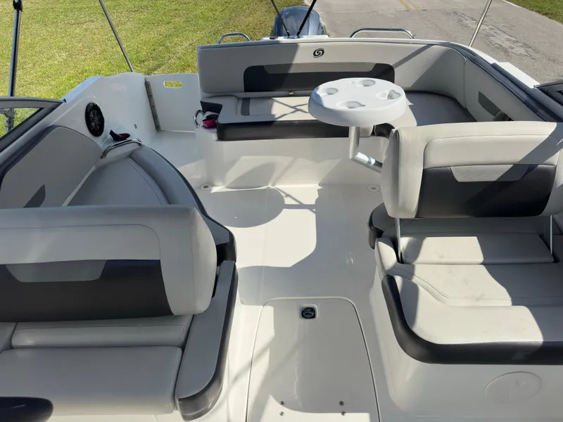 Slide: The Image of 2022 Hurricane SunDeck 235 OB boat interior with seating and table. - 21