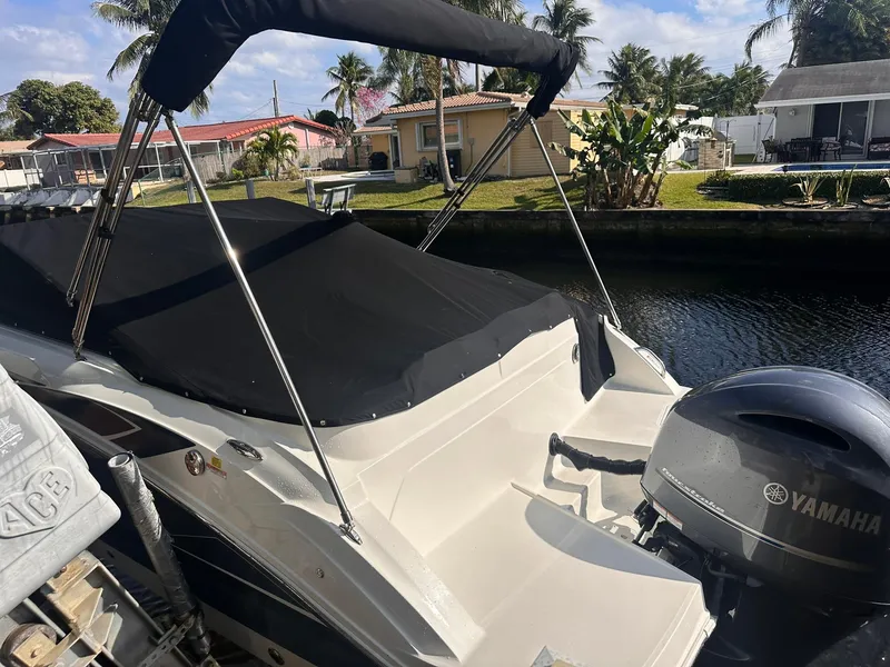 Slide: The Image of 2022 Hurricane SunDeck 235 OB boat with Yamaha engine docked by a canal. - 26