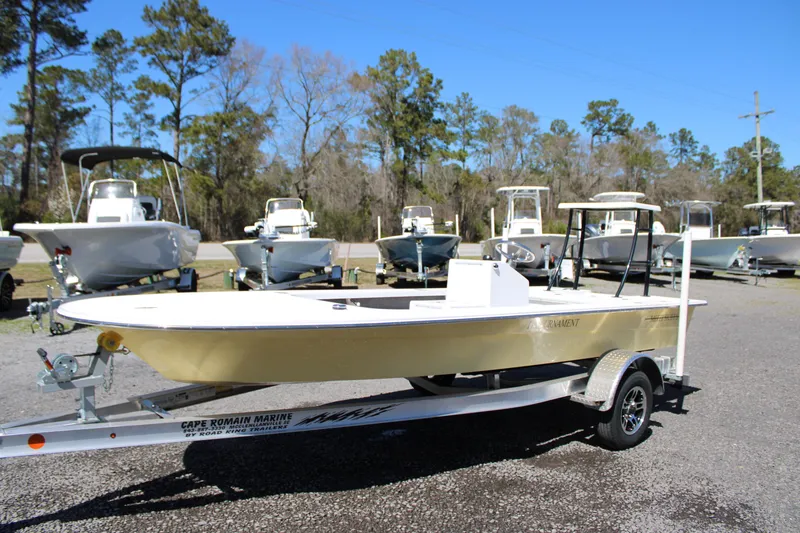 Slide: The Image of 2025 Mitzi Skiffs 17 Tournament boat on trailer, surrounded by other boats, outdoor setting. - 1