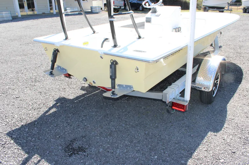 Slide: The Image of 2025 Mitzi Skiffs 17 Tournament boat on trailer, rear view, parked on gravel. - 11