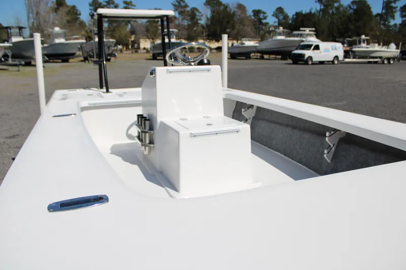 Slide: The Image of 2025 Mitzi Skiffs 17 Tournament boat, white interior, parked outdoors with other boats. - 19