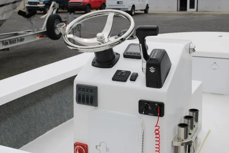 Slide: The Image of 2025 Mitzi Skiffs 17 Tournament boat console with steering wheel and controls. - 2
