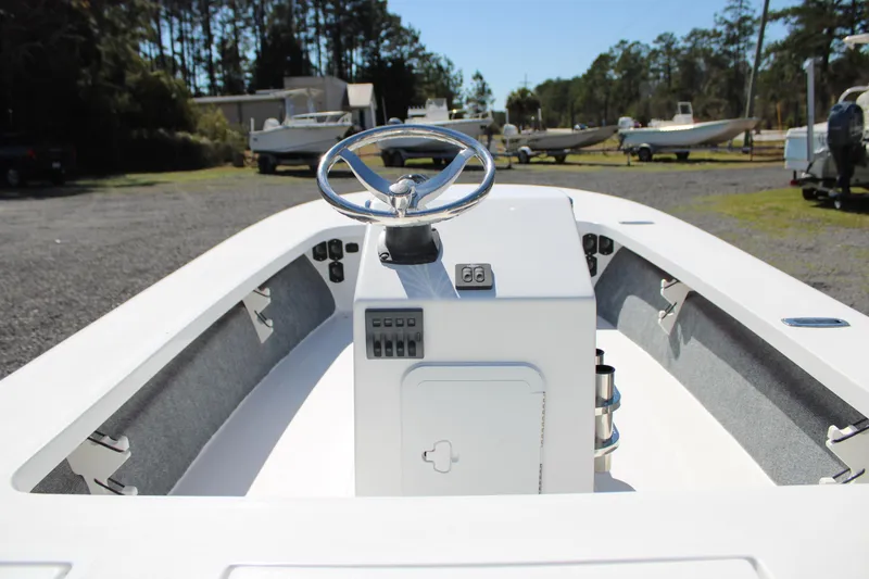 Slide: The Image of 2025 Mitzi Skiffs 17 Tournament boat interior with steering wheel, parked outdoors. - 20