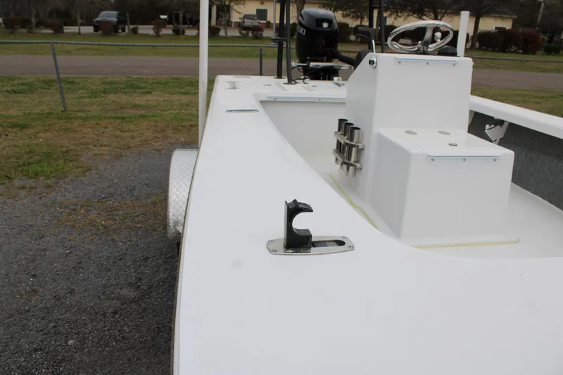 Slide: The Image of 2025 Mitzi Skiffs 17 Tournament boat, white deck, parked on gravel. - 26