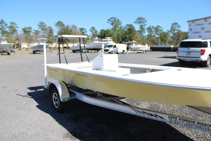 Slide: The Image of 2025 Mitzi Skiffs 17 Tournament boat on trailer in parking lot, surrounded by trees and vehicles. - 3