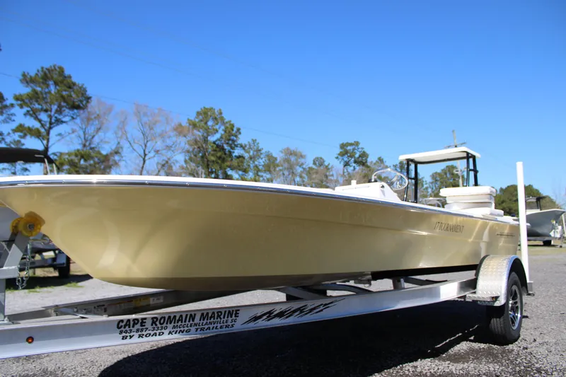 Slide: The Image of 2025 Mitzi Skiffs 17 Tournament boat on trailer, parked outdoors under clear blue sky. - 4