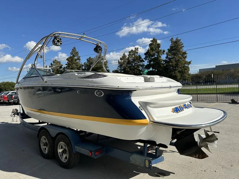 Slide: The Image of 2006 Cobalt 250 boat on trailer under clear blue sky. - 7