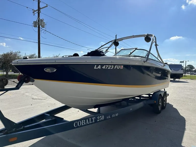 Slide: The Image of 2006 Cobalt 250 boat on trailer under clear blue sky. - 9
