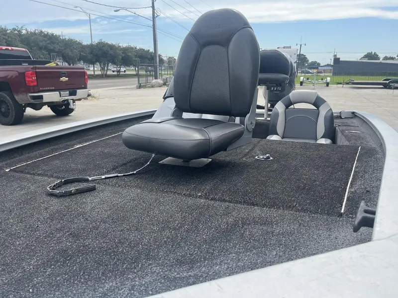 Slide: The Image of 2012 Xpress Xclusive Series X17 boat with black seating on a carpeted deck. - 11