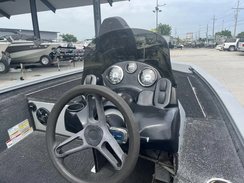 Slide: The Image of Steering console of 2012 Xpress Xclusive Series X17 boat, featuring gauges and controls. - 13