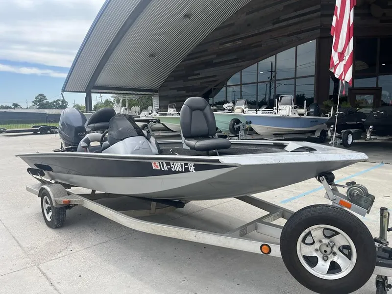 Slide: The Image of 2012 Xpress Xclusive Series X17 boat on trailer, parked outdoors near a building. - 3
