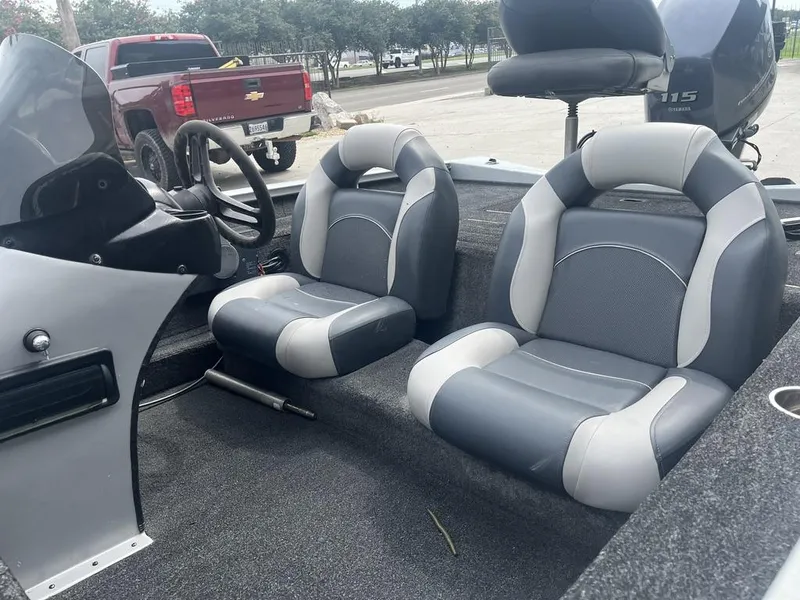 Slide: The Image of Interior of 2012 Xpress Xclusive Series X17 boat with gray seating and steering wheel. - 6