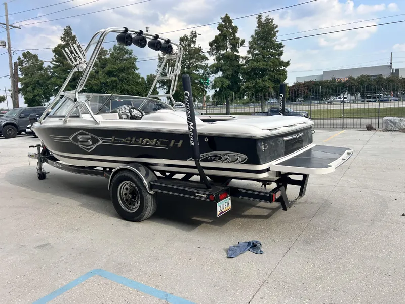 Slide: The Image of 2003 Supra Launch LTS boat on trailer, parked outdoors. - 2