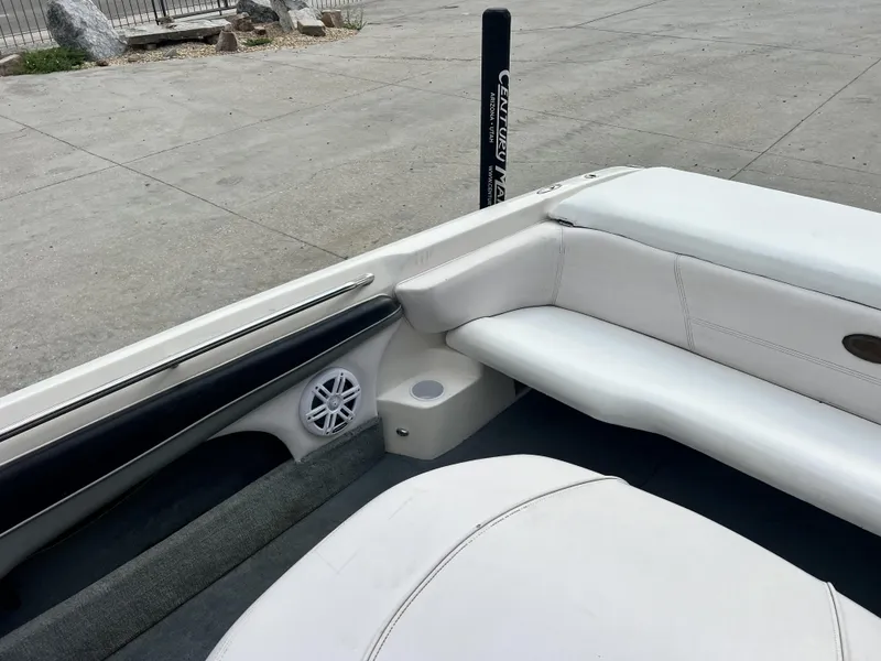 Slide: The Image of 2003 Supra Launch LTS boat interior with white seating and speaker. - 4