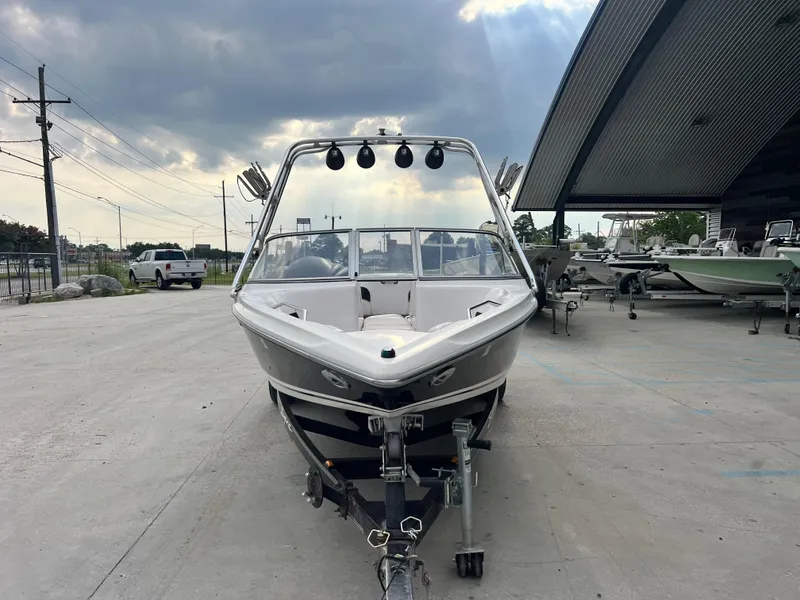Slide: The Image of 2003 Supra Launch LTS boat on trailer under cloudy sky. - 8