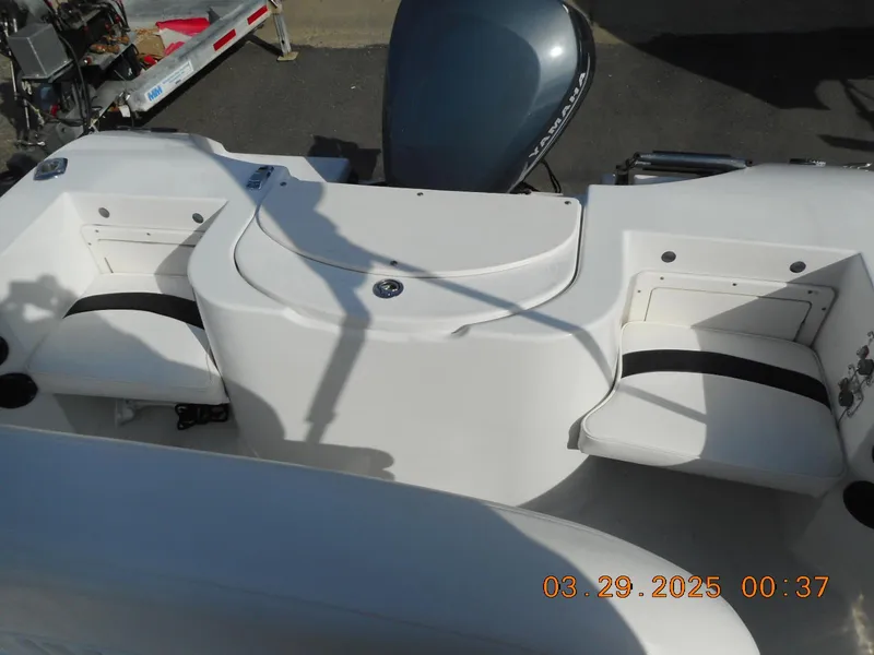Slide: The Image of 2002 Seaswirl Striper 1851 Center Console boat interior with seating and motor. - 11