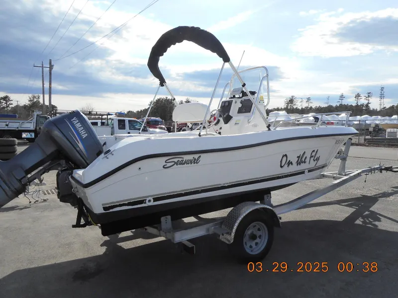 Slide: The Image of 2002 Seaswirl Striper 1851 Center Console boat on trailer, Yamaha outboard motor. - 2
