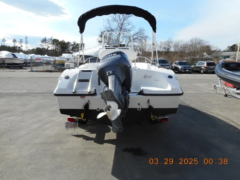 Slide: The Image of 2002 Seaswirl Striper 1851 Center Console boat with outboard motor, parked outdoors. - 4