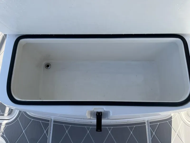 Slide: The Image of 2023 Sea Cat 262 Ultimate Edition boat interior with diamond-patterned flooring and speaker. - 21