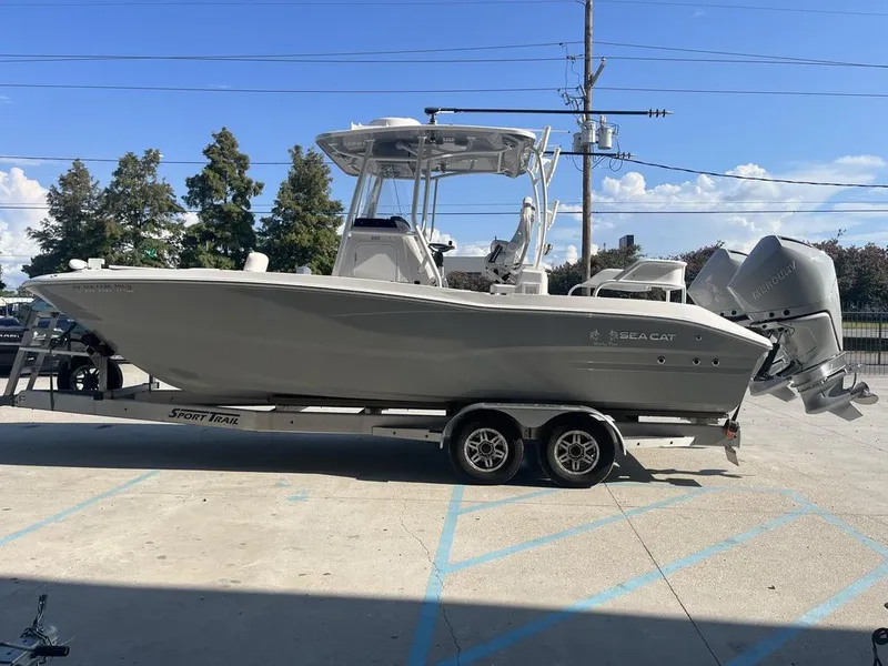 Slide: The Image of 2023 Sea Cat 262 Ultimate Edition boat on trailer under clear sky. - 4