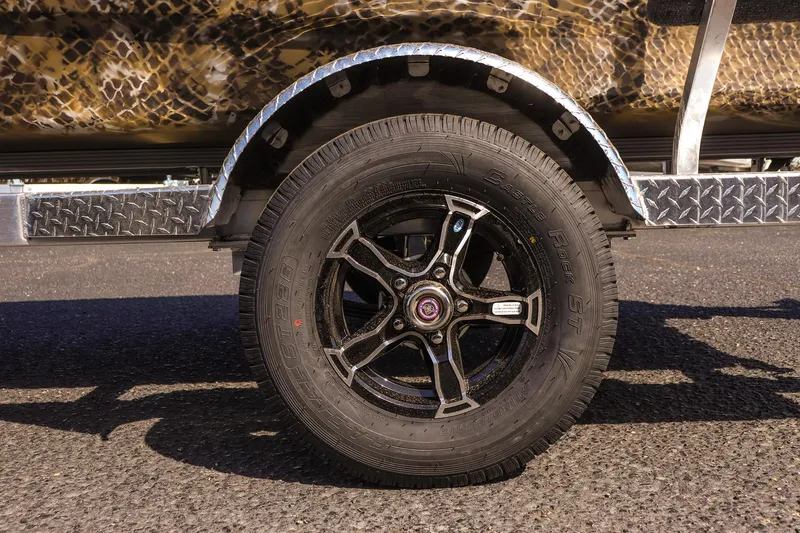 Slide: The Image of 2025 Excel 1751 F4 Shallow Water boat trailer wheel with camouflage design. - 11