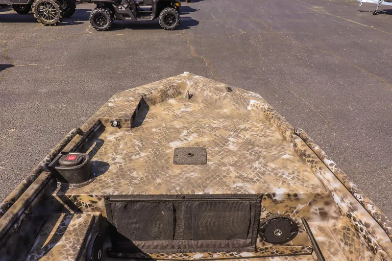 Slide: The Image of 2025 Excel 1751 F4 Shallow Water boat with camouflage design in a parking lot. - 15