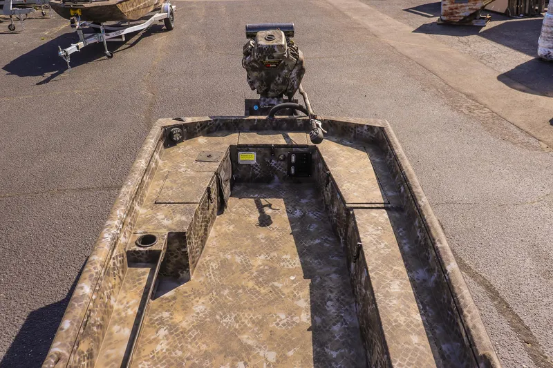 Slide: The Image of 2025 Excel 1751 F4 Shallow Water boat with camouflage design, parked on pavement. - 16