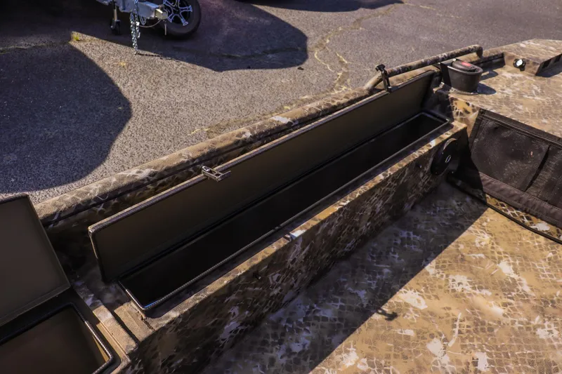 Slide: The Image of 2025 Excel 1751 F4 Shallow Water boat with open storage compartment, camo design. - 18