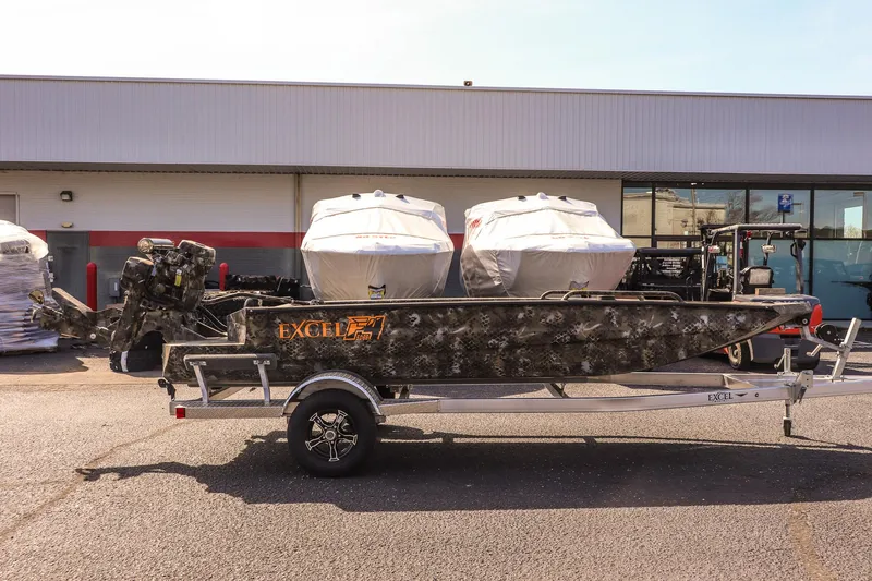 Slide: The Image of 2025 Excel 1751 F4 Shallow Water boat on trailer, parked outdoors. - 4
