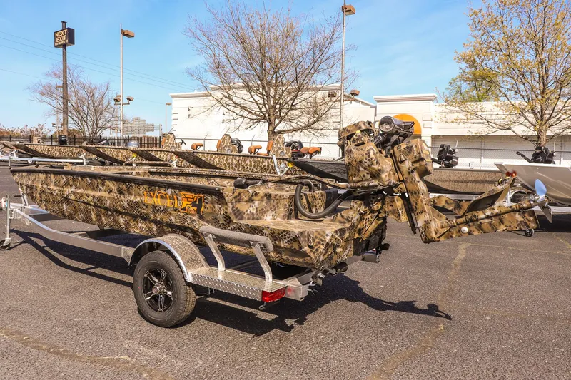 Slide: The Image of 2025 Excel 1751 F4 Shallow Water boat with camouflage design on a trailer. - 8