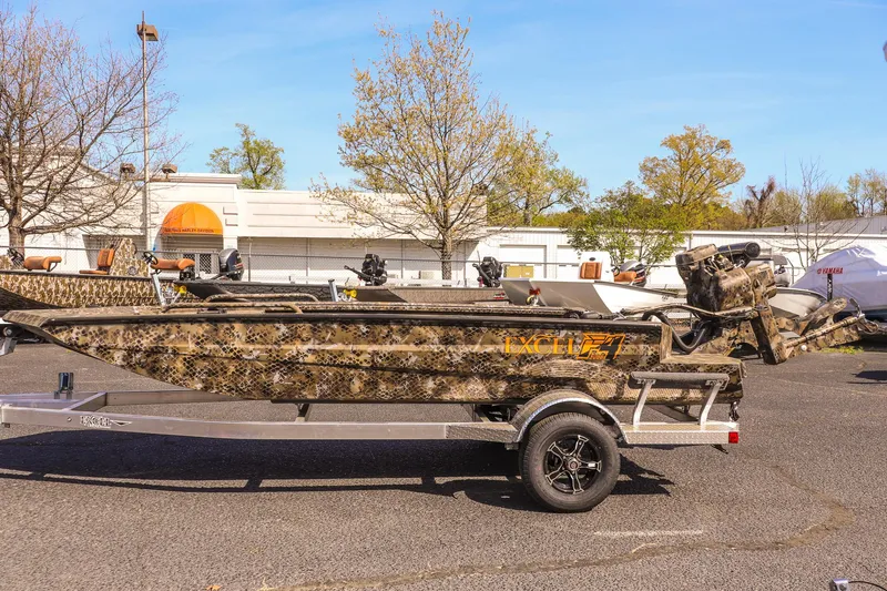 Slide: The Image of 2025 Excel 1751 F4 Shallow Water boat with camouflage design on a trailer. - 9
