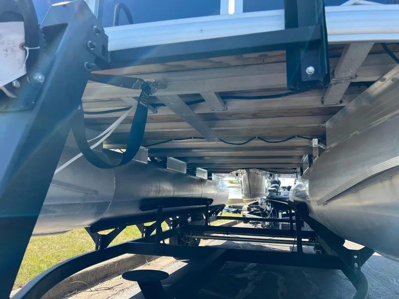 Slide: The Image of Underneath view of 2023 Sun Tracker Party Barge 20 DLX pontoon boat on trailer. - 10