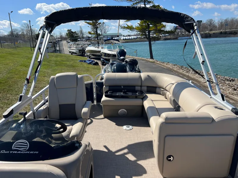 Slide: The Image of 2023 Sun Tracker Party Barge 20 DLX pontoon boat docked by a scenic lakeside. - 15