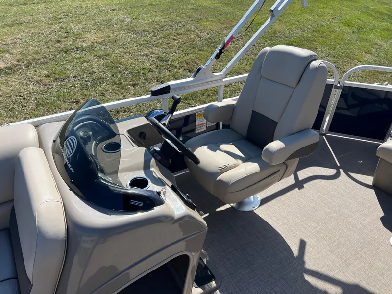 Slide: The Image of 2023 Sun Tracker Party Barge 20 DLX interior with captain's chair and console. - 16