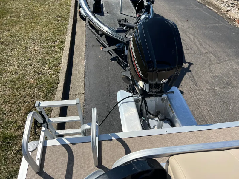 Slide: The Image of 2023 Sun Tracker Party Barge 20 DLX with outboard motor and boarding ladder. - 19