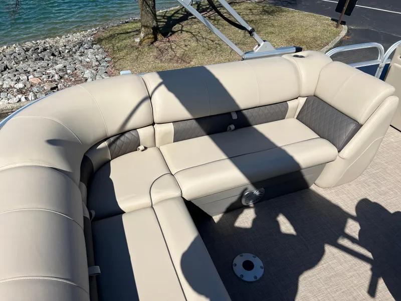 Slide: The Image of 2023 Sun Tracker Party Barge 20 DLX interior seating by the water. - 20