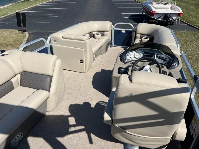 Slide: The Image of 2023 Sun Tracker Party Barge 20 DLX with beige seating and steering console. - 21