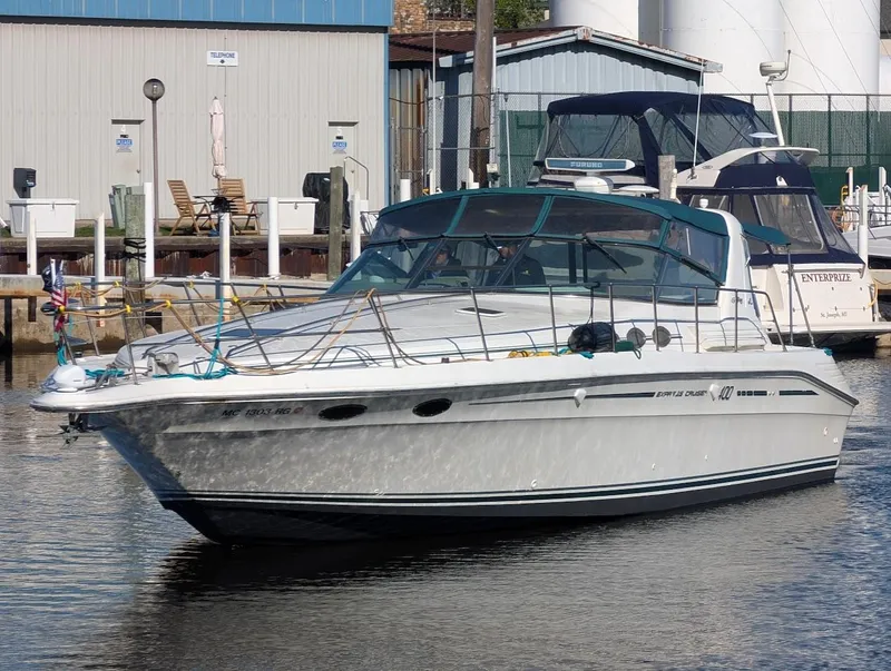 The Image of 1995 Sea Ray 400 Express Cruiser docked at a marina. - 0