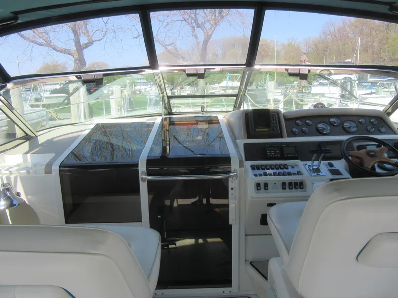 Slide: The Image of 1995 Sea Ray 400 Express Cruiser cockpit with steering wheel and control panel. - 18