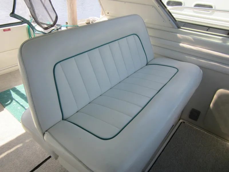 Slide: The Image of 1995 Sea Ray 400 Express Cruiser interior seating with white upholstery and green trim. - 19