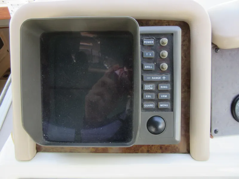 Slide: The Image of 1995 Sea Ray 400 Express Cruiser control panel with buttons and display screen. - 23