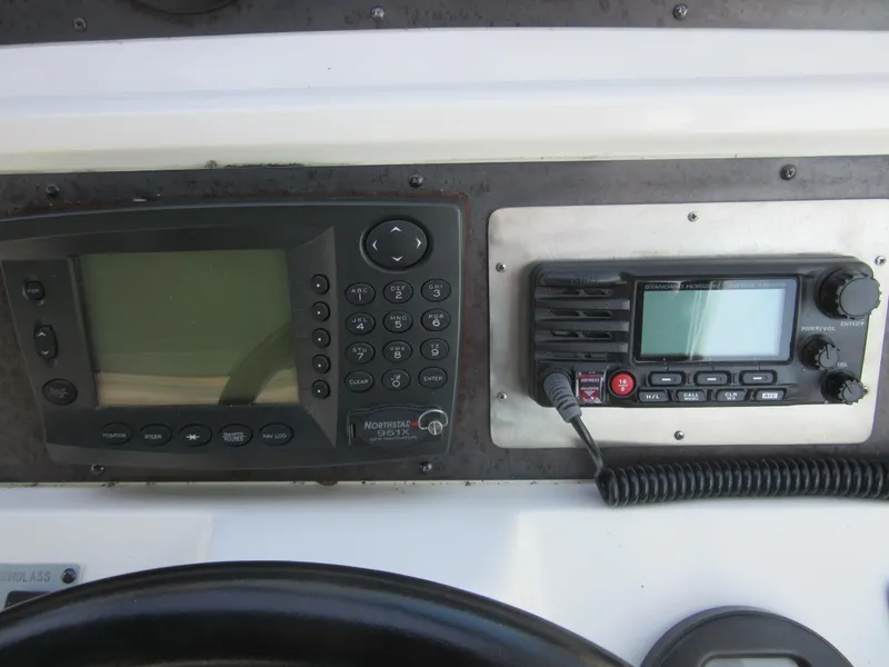 Slide: The Image of Control panel of a 1995 Sea Ray 400 Express Cruiser with navigation and communication devices. - 25