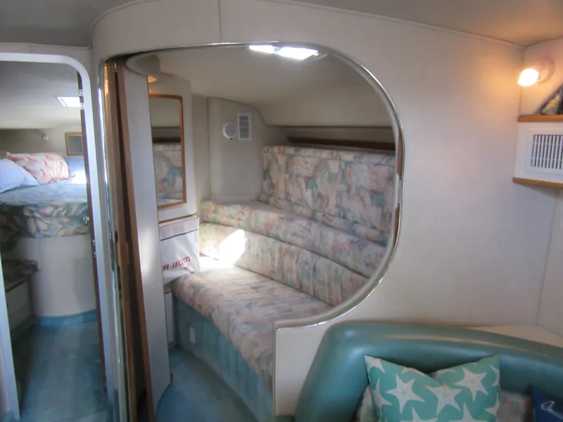 Slide: The Image of Interior of 1995 Sea Ray 400 Express Cruiser with cozy seating and nautical decor. - 35