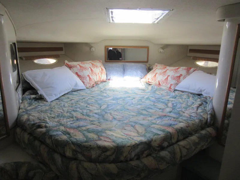 Slide: The Image of Cozy cabin interior of 1995 Sea Ray 400 Express Cruiser with patterned bedding. - 36