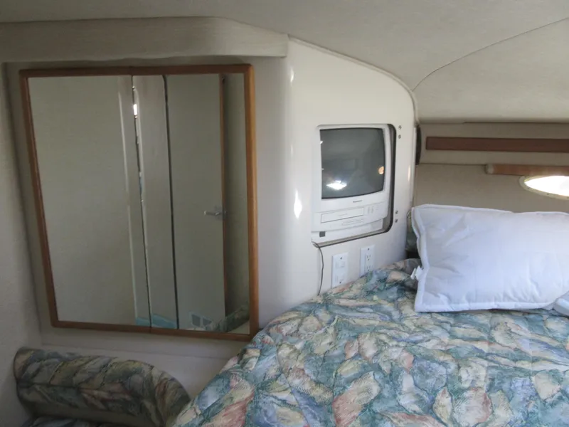 Slide: The Image of 1995 Sea Ray 400 Express Cruiser cabin with bed, TV, and mirror. - 37