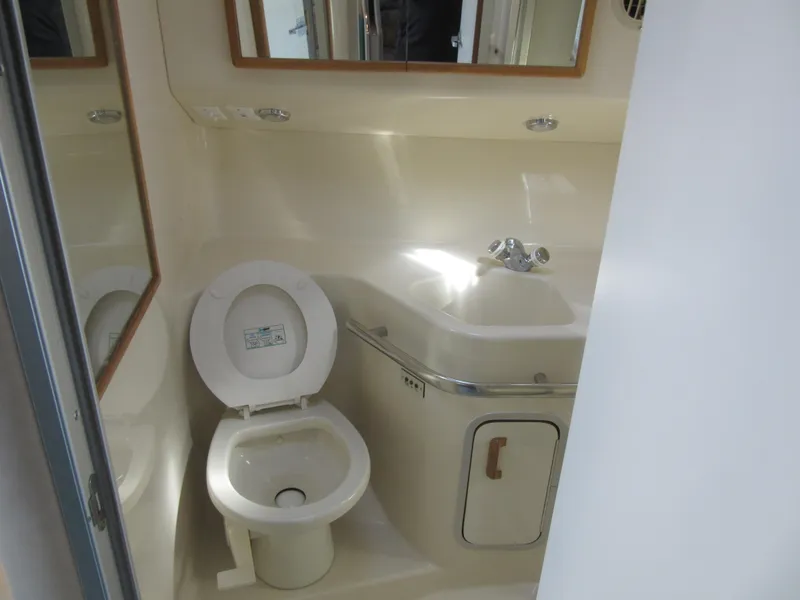 Slide: The Image of Bathroom interior of 1995 Sea Ray 400 Express Cruiser with toilet and sink. - 39