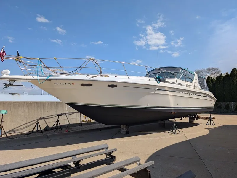 Slide: The Image of 1995 Sea Ray 400 Express Cruiser on dry dock under clear blue sky. - 4