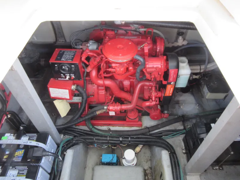 Slide: The Image of Engine compartment of a 1995 Sea Ray 400 Express Cruiser with red engine components. - 43