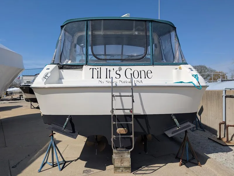 Slide: The Image of 1995 Sea Ray 400 Express Cruiser on stands, named "Til It's Gone," with ladder access. - 6